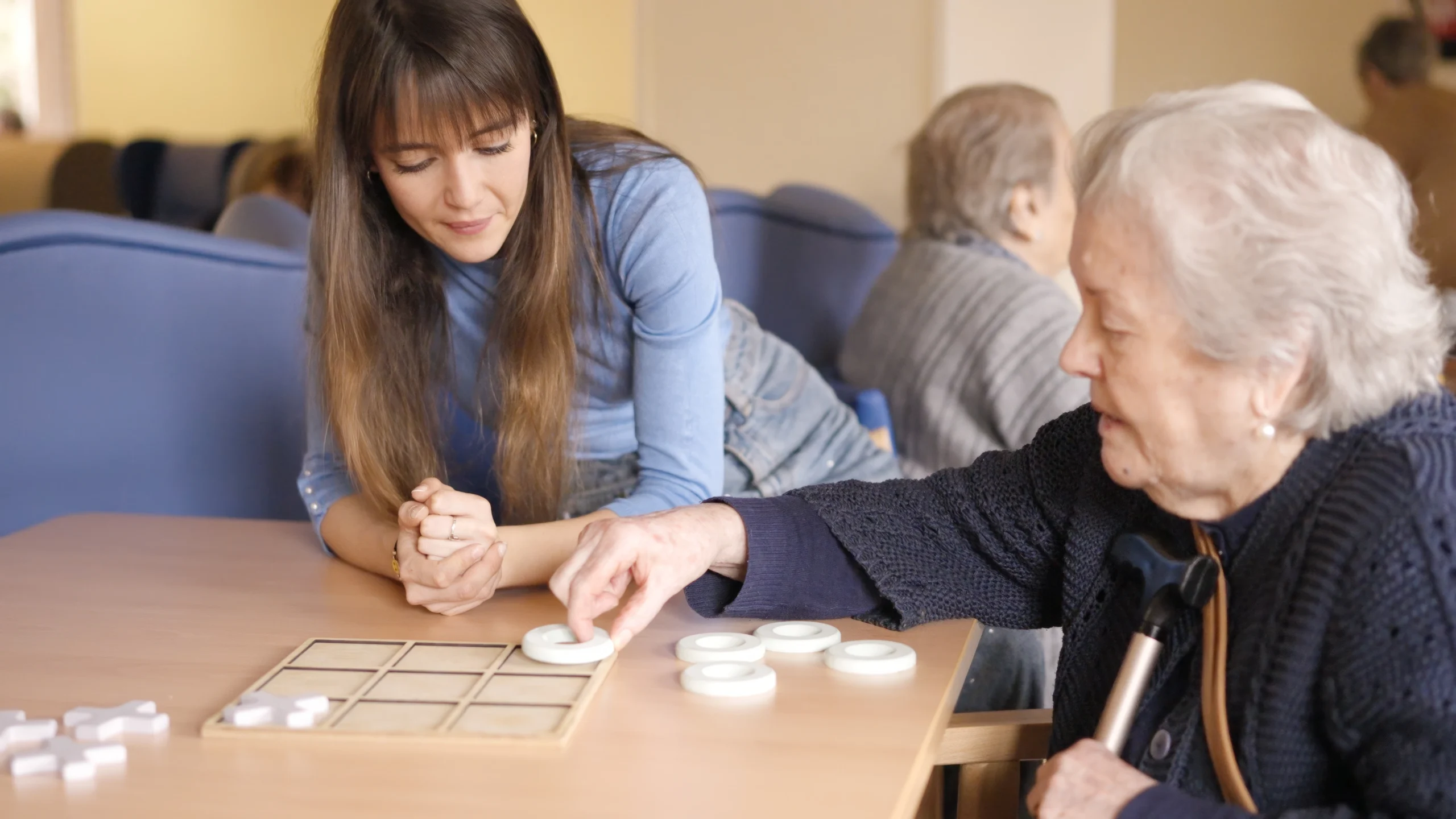 lady with dementia playing memory games with caregiver