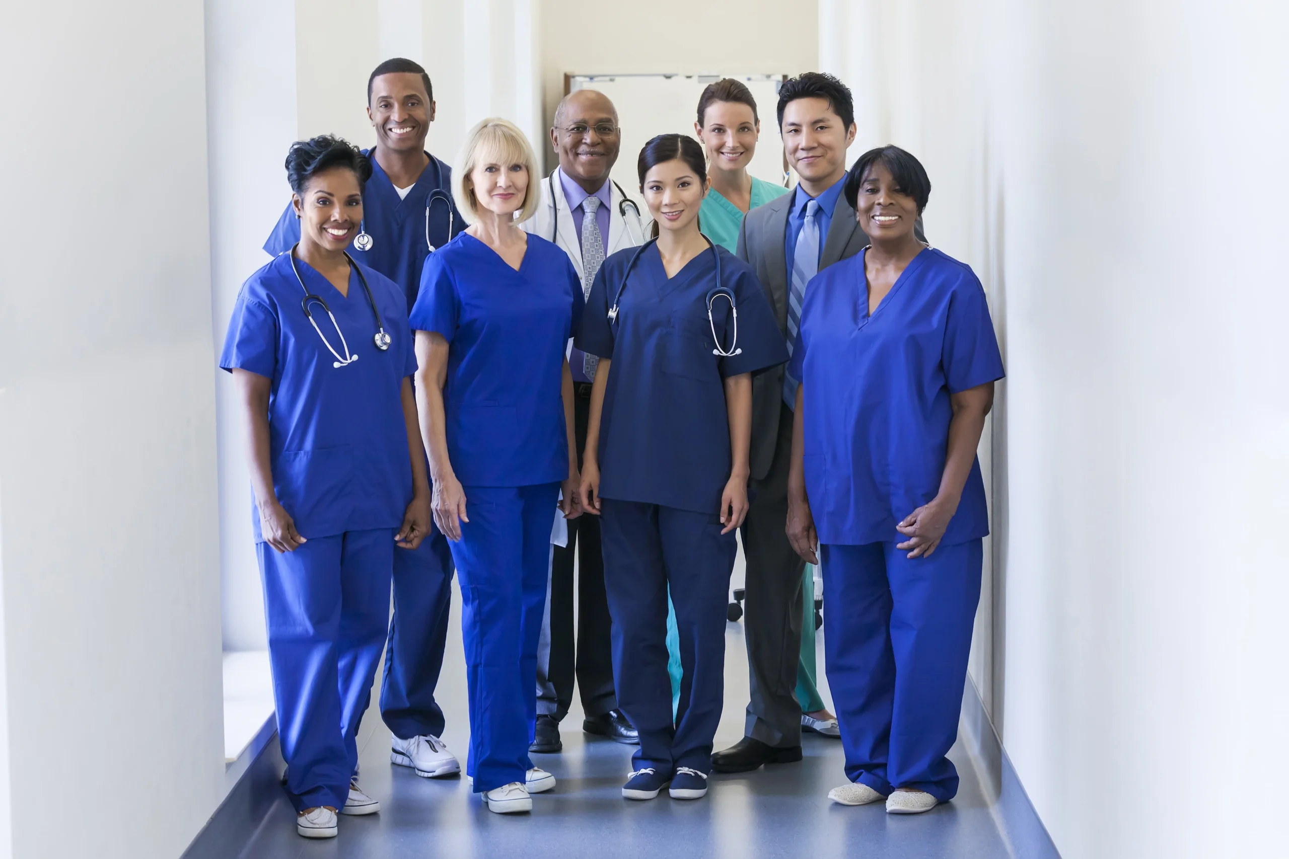 diverse group of nurses standing at attention